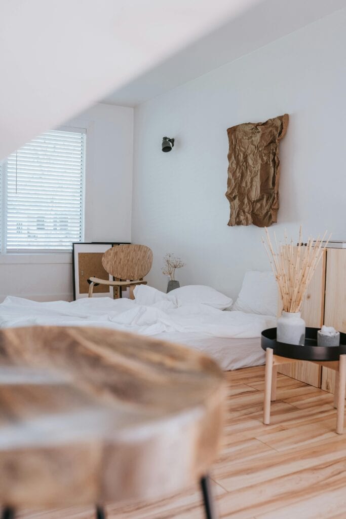Styled cozy bedroom with peach bedding and warm nightstand decor on a budget